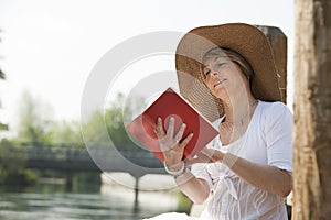 Woman reading by the river