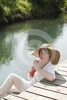 Woman reading by the river