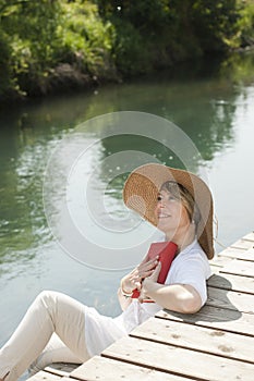 Woman reading by the river