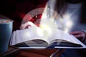 Woman reading shiny magic book, closeup