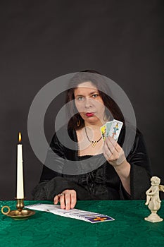 A woman is reading tarot cards