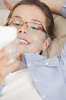 Woman reading text message on a mobile phone