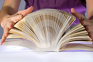 Woman reading a thick book