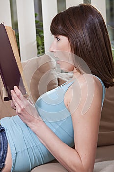 Woman reading thriller book photo