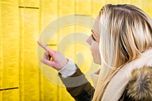 Woman reading time table in train station