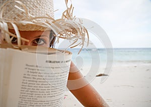 Woman reads a book on beach