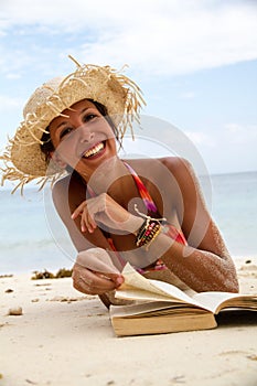 Woman reads a book on beach