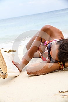 Woman reads a book on beach