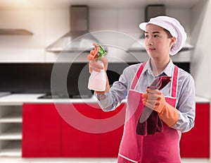 Woman ready to cleaning house on blurred kitchen background