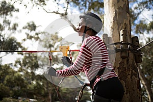 Woman ready to zip line in adventure park