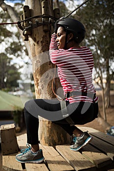 Woman ready to zip line in adventure park