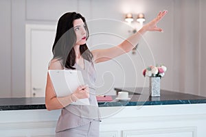 Woman realtor proposes to visit flat or apartment. Agent shows with hand something apartment.