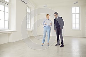 Woman Realtor Showing New Home Or Office To Business Client