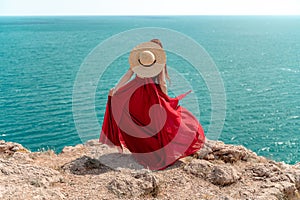 A woman, rear view in a red flying dress fluttering in the wind, a girl in a fluttering dress on the background of the