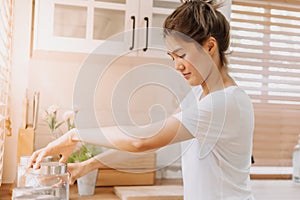 Woman rearrange equipments items and cleaning the kitchen.