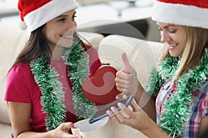 Woman receive present from sister in red box new model of smartphone