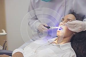 A woman receives a dental examination in a dentist`s office