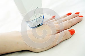 Woman receives laser and ultrasound treatment of face and body and hands in a medical sanatorium, skin rejuvenation concept photo
