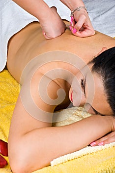 Woman receiving a back massage at spa