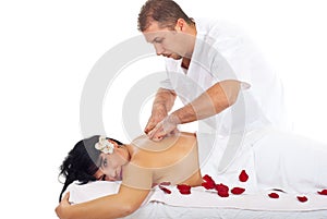 Woman receiving back massage at spa