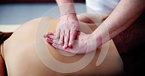 Woman Receiving Back Massage From Therapist