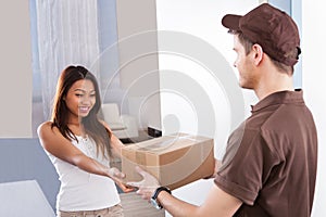 Woman receiving courier from delivery man