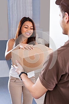 Woman receiving courier from delivery man