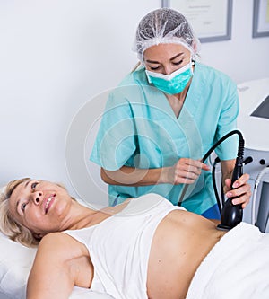 Woman receiving cryoliposuction