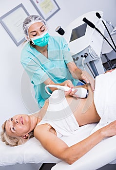 Woman receiving cryoliposuction