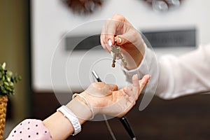 Woman receiving door key in hotel front desk