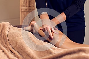 Woman receiving and enjoying a foot massage at the spa salon