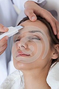 Woman receiving facial rejuvenating treatments