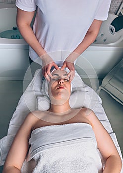 Woman receiving facial treatment on clinical center