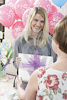 Woman Receiving Gift At Baby Shower