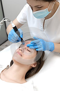 Woman receiving hydrafacial treatment in beauty salon