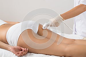 Woman receiving laser treatment on buttock photo