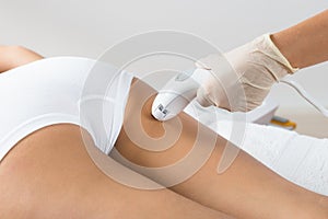 Woman receiving laser treatment on buttock photo