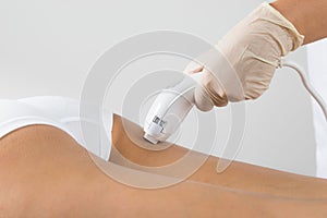 Woman receiving laser treatment on buttock photo