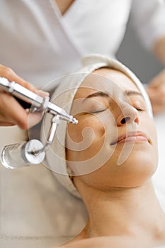 Woman receiving oxygen mesotherapy on her face,