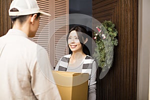 Woman receiving package from delivery man