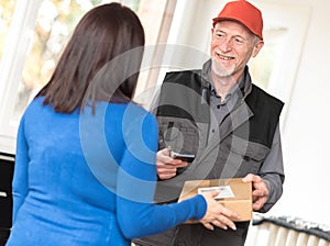 Woman receiving package from delivery man