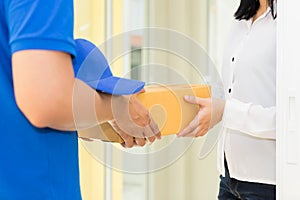 Woman receiving package from delivery man