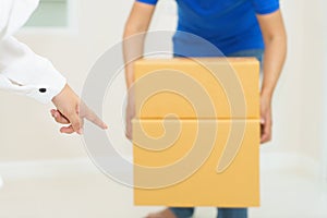 Woman receiving package from delivery man - put it down.