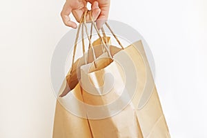 Woman receiving a package at home from a delivery man. Copy space. Close-up. White background