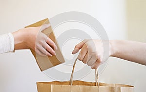 Woman receiving a package at home from a delivery man. Copy space. mockup, Close-up. White background