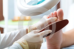 Woman receiving podiatry treatment in Day Spa