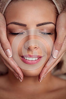 Woman receiving professional face massage