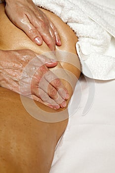 Woman receiving a professional massage and lymphatic drainage -various techniques demonstration