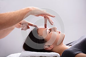 Woman Receiving Reiki Treatment