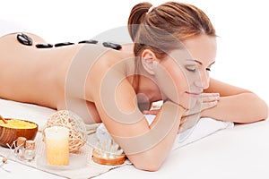 Woman receiving spa stones therapy